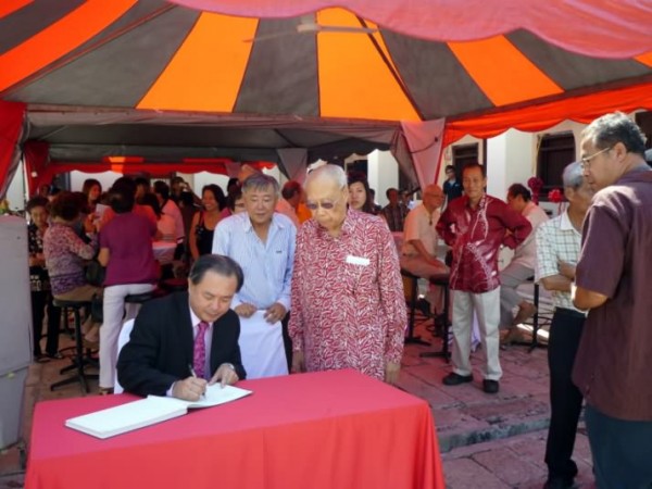 Y.B. Danny Law signing the guest book upon arrival.