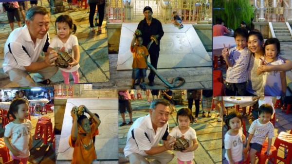 Snake Performer with his brave little nephew.  Looking at the little girl in the photo, I must say she is indeed one amazing little girl, fearlessly holding the snake.  Remarkable.